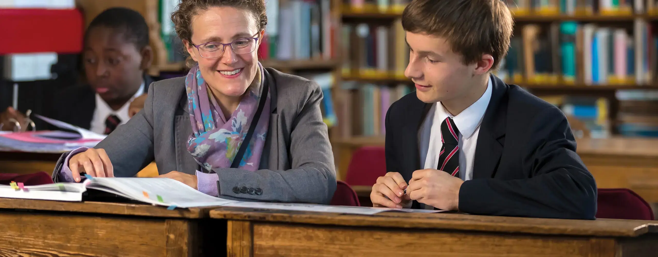 Student and teacher collaborating in a library