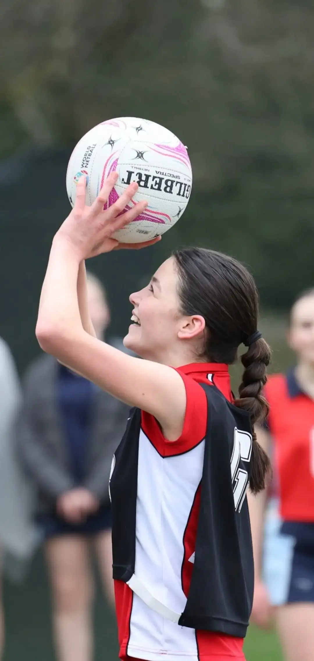 Netball player lining up a shot