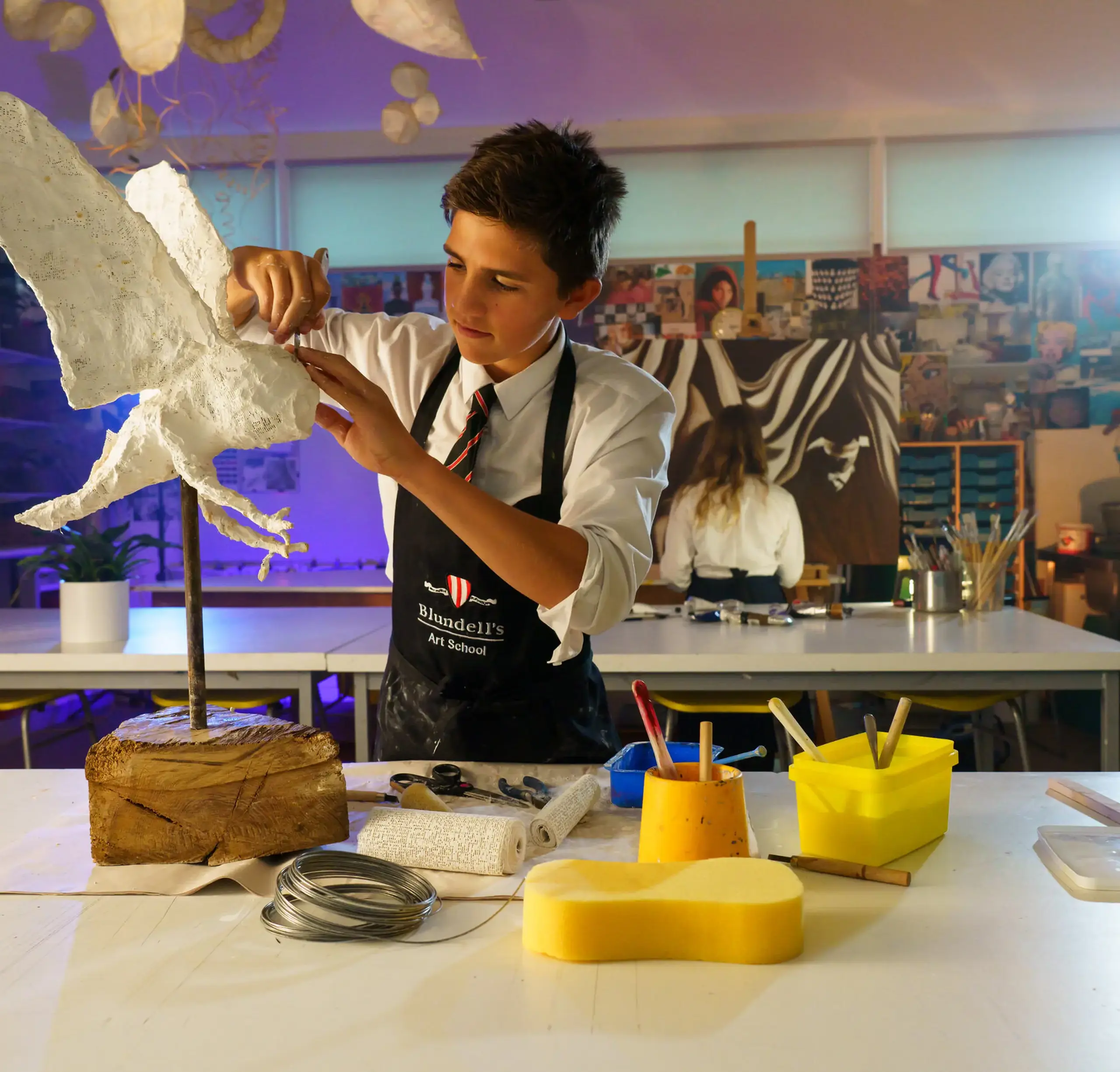 Student sculpting a bird