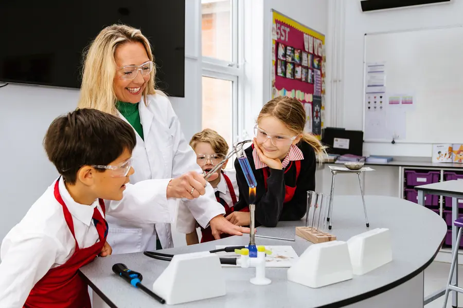 teacher demonstrating science experiment pupils smiling blundells pre school private prep school in devon