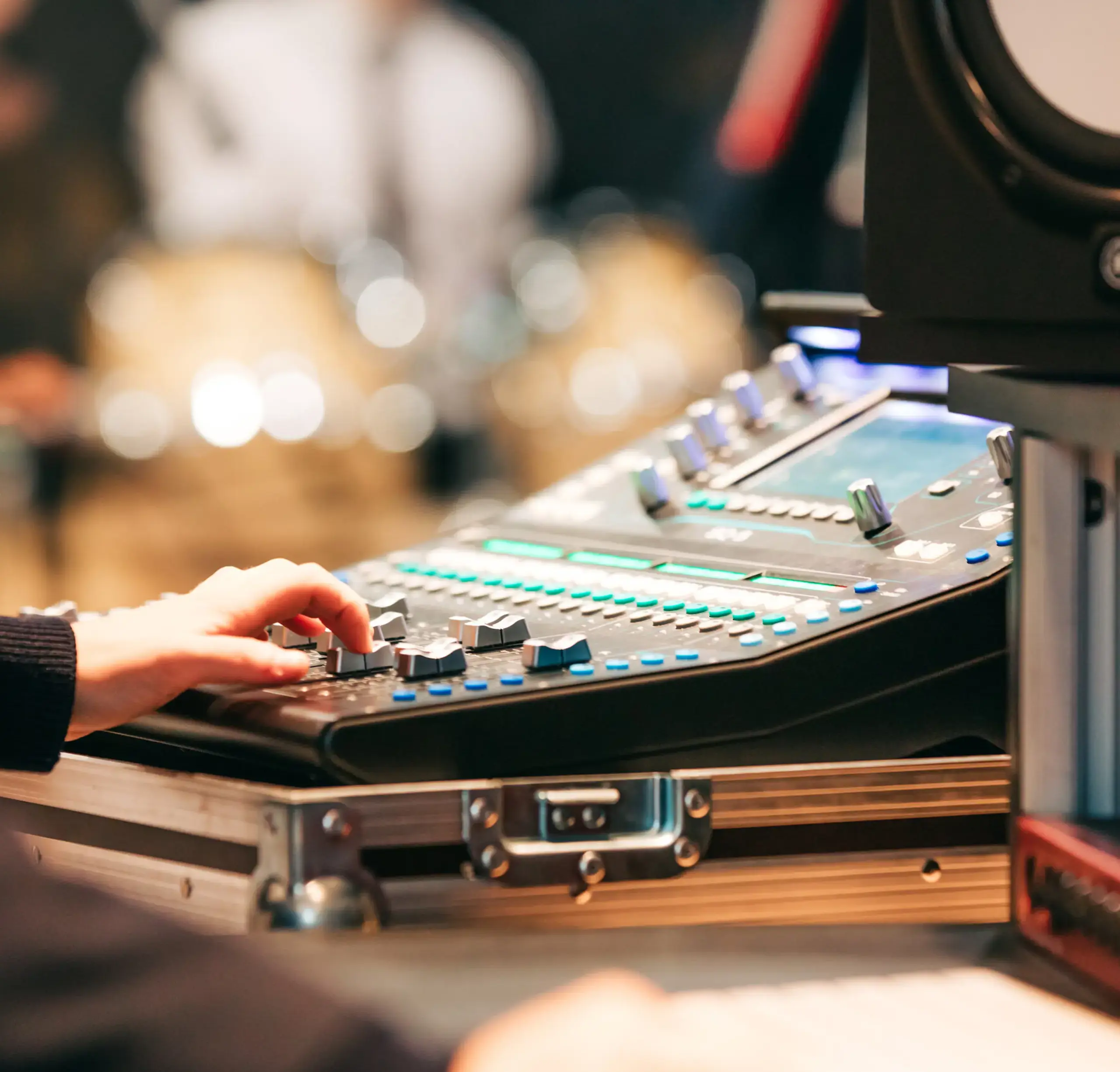 Hand interacting with music production deck