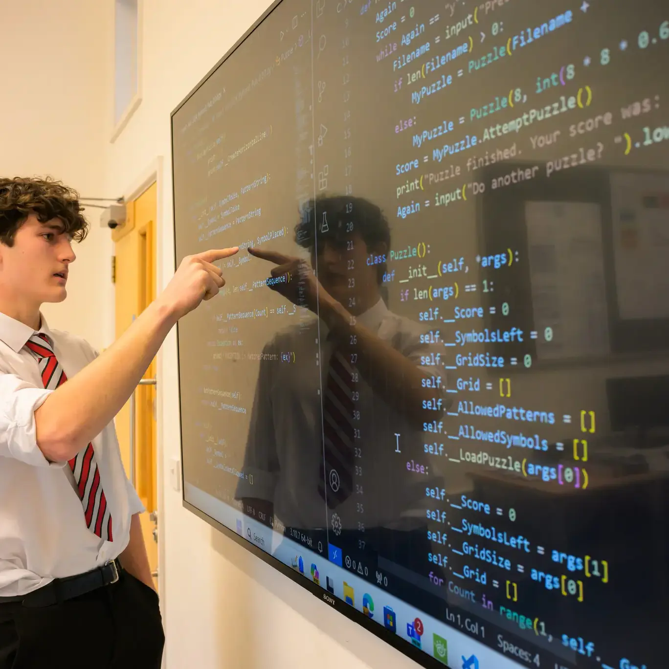 Pupil demonstrating some code on a screen